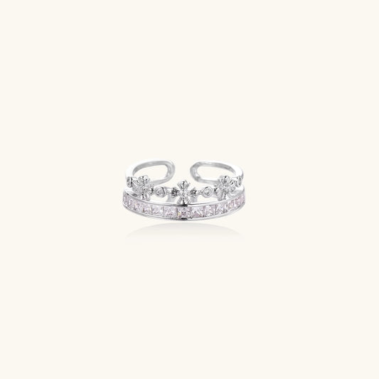 Silver-toned adjustable crown ring with channel-set square zirconia stones and delicate floral details on white background