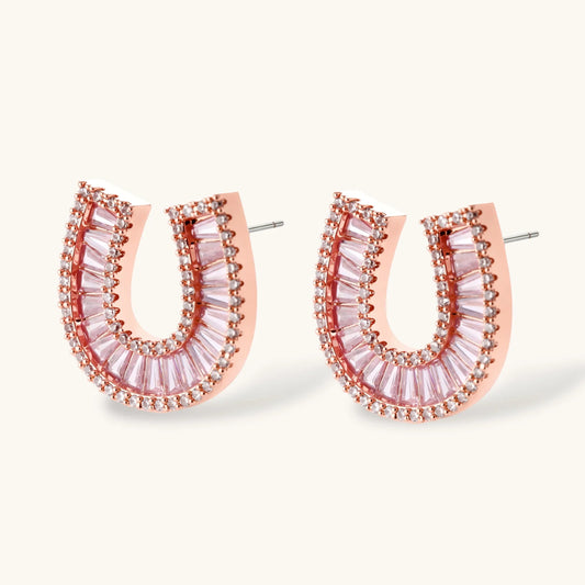 Sparkling horseshoe-shaped jewelry set with AAA cubic zirconia in gold-plated and white gold finishes on cream background.