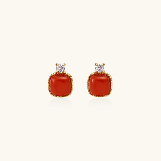 18K gold vermeil stud earrings with cushion-cut red agate stones and sparkling crystal accents on beige background