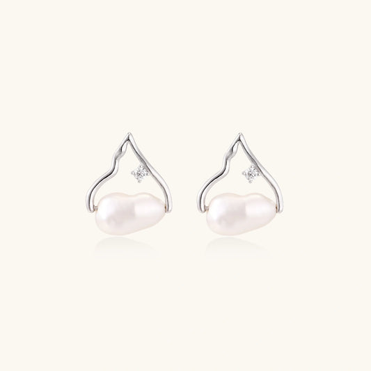 Silver mountain outline studs with baroque pearl and diamond accent on white background