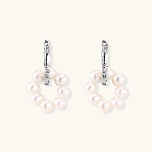 Rhodium-plated silver hoop earrings with freshwater pearls arranged in crescent formation and diamond accents