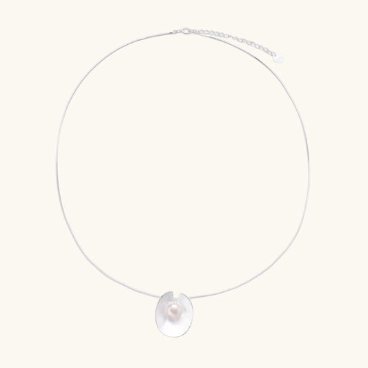 Sterling silver disc necklace with textured finish and centered freshwater pearl on delicate chain