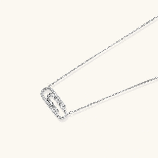 White gold plated necklace with dual-frame geometric pendant featuring crystal pavé border on pale background.