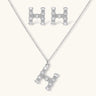 Letter H jewelry set featuring geometric crystal design in gold and white gold plated finish with adjustable chain necklace