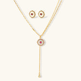 Gold-plated circular medallion necklace set with white enamel base and pink cubic zirconia accent stones