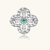 Sterling silver adjustable ring featuring four-leaf clover design with green center moissanite and clear accent stones