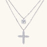Two delicate sterling silver necklaces with moissanite stones - one solitaire pendant and one cross pendant on white background.