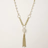 Long gold-plated necklace with freshwater pearls, chunky chain links, and flowing tassel pendant
