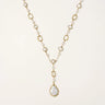 Long gold-plated necklace with alternating freshwater pearls and crystal bezels, featuring a large baroque pearl pendant
