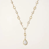 Long gold-plated necklace with alternating freshwater pearls and crystal bezels, featuring a large baroque pearl pendant