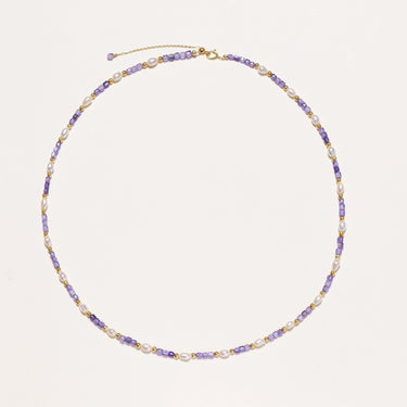 Delicate 18K gold vermeil necklace with alternating lavender zirconia beads and white freshwater pearls on cream background