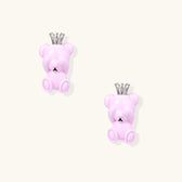 Lavender pink teddy bear earrings with silver crowns, white gold plated brass, viewed from back on cream background
