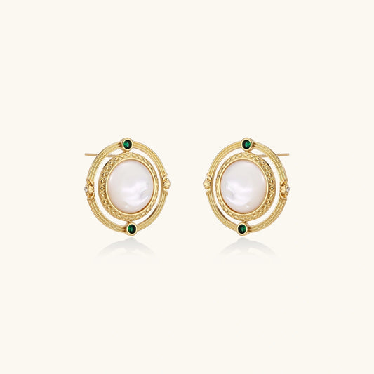 Circular gold stud earrings with iridescent mother-of-pearl center and green zirconia accents on cream background.