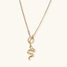 Sculptural gold snake pendant on delicate chain with toggle clasp, featuring smooth curves and polished 14K gold plated finish