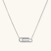 White gold plated necklace with dual-frame geometric pendant featuring crystal pavé border on pale background.