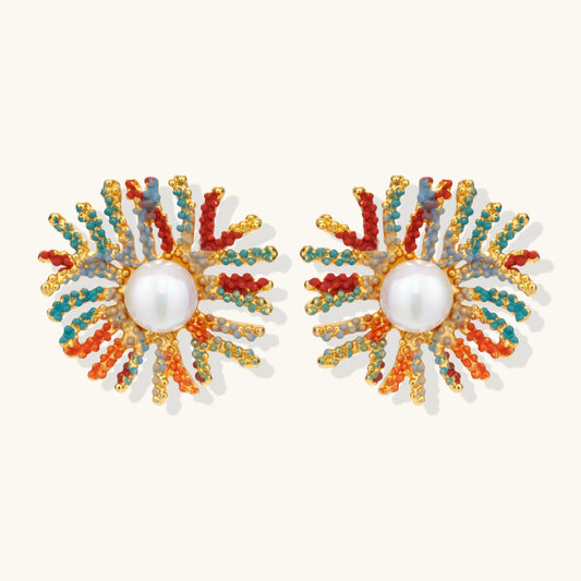 Vibrant starburst stud earrings with multicolor enamel rays and white pearl centers on gold-plated setting