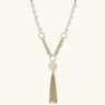Long gold-plated necklace with freshwater pearls, chunky chain links, and flowing tassel pendant
