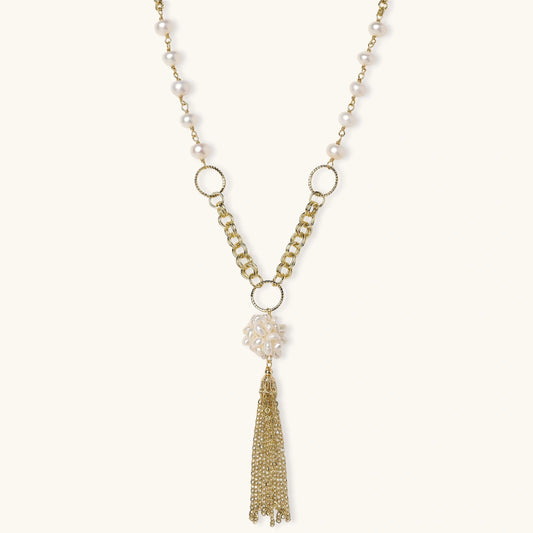 Long gold-plated necklace with freshwater pearls, chunky chain links, and flowing tassel pendant